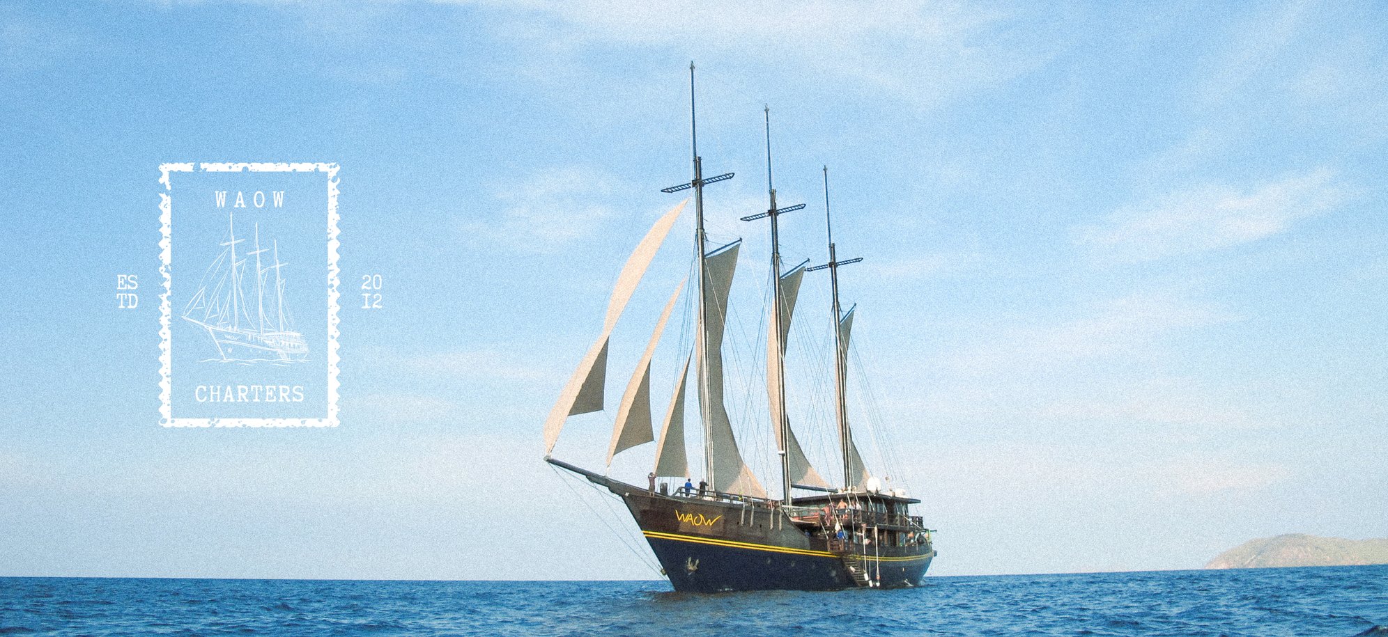 Waow 2, a traditional three-masted phinisi, under full sail.